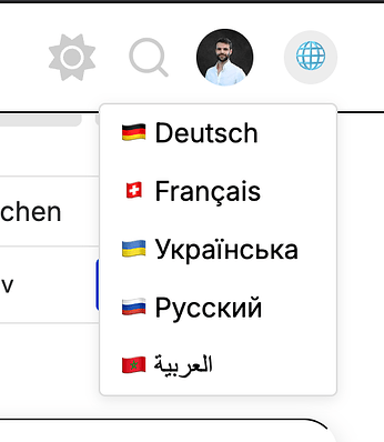 Sprachauswahl-Menü in der EnableMe Community mit den Optionen Deutsch, Französisch, Ukrainisch, Russisch und Arabisch, jeweils mit zugehöriger Flagge.